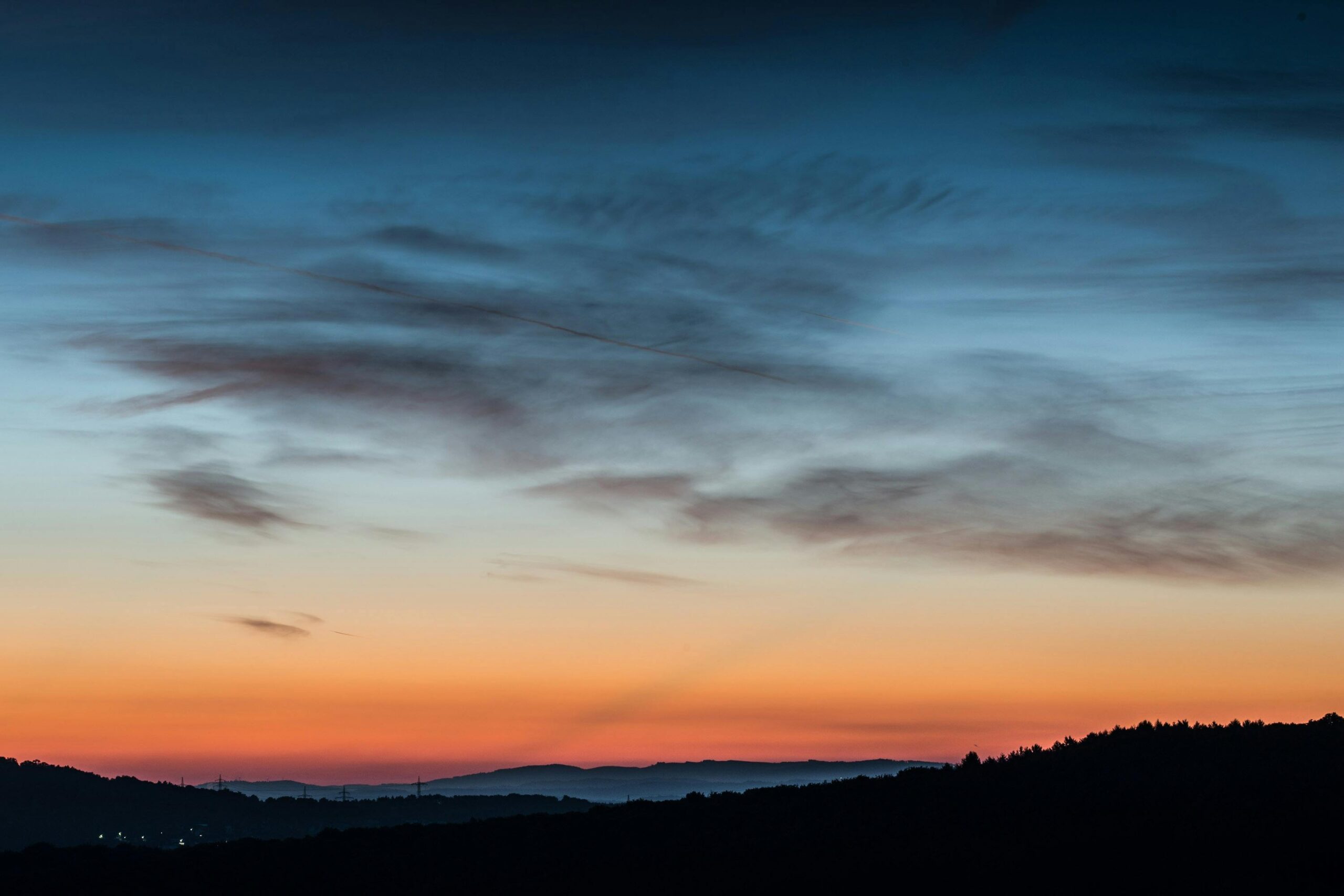A captivating twilight sky with vibrant colors over a serene landscape.